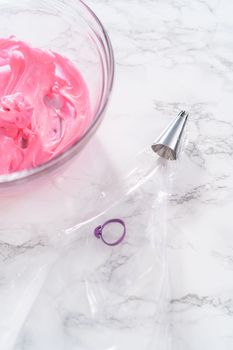 Filling piping bags with meringue to pipe Easter meringue cookies.