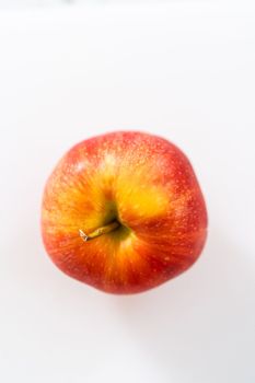 Slicing red apples into thin slices on a white cutting board.