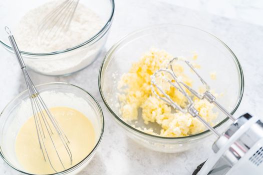 Mixing ingredients in a glass mixing bowl to bake July 4th bundt cake with chocolate stars.