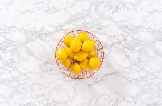Flat lay. Ingredients in glass mixing bowls to prepare lemon bundt cake.