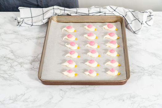 Freshly baked Easter meringue cookies in the shape of birds.