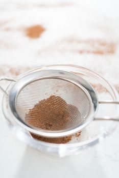 Mixing ingredients in a glass mixing bowl to bake chocolate graham crackers.