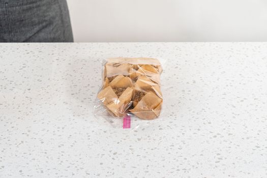Meal prepping. Packaging banana oatmeal muffins into the plastic back to store in a freezer.