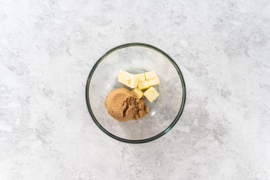 Flat lay. Mixing ingredients in a large glass mixing bowl to bake eggnog scones.