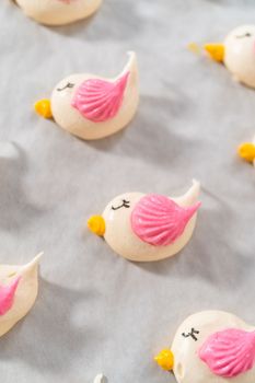Freshly baked Easter meringue cookies in the shape of birds.