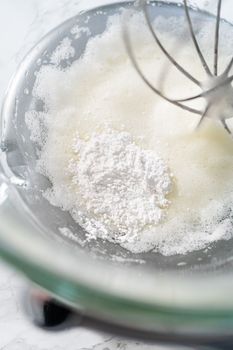 Mixing ingredients in kitchen mixer to bake Easter meringue cookies.