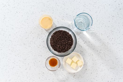 Flat lay. Measured ingredients in glass mixing bowls to make plain fudge.