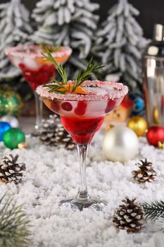 Christmas Cranberry margarita cocktail is mandarin and rosemary combined with cranberries and tequila. This cocktail is bursting with vibrant citrus and herb aromas, showcasing the best winter season fruits.Festive Christmas or New Year drink