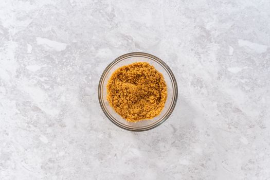Flat lay. Mixing ingredients in a glass mixing bowl to bake s'mores cupcakes.