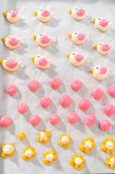 Freshly baked Easter meringue cookies in the shape of birds.