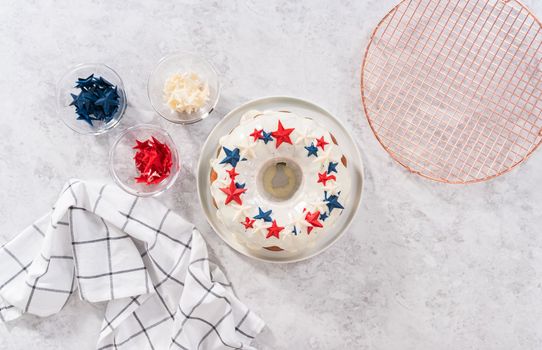 Flat lay. Decorating freshly baked bundt cake with chocolate stars for the July 4th celebration.
