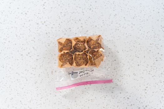 Flat lay. Meal prepping. Packaging banana oatmeal muffins into the plastic back to store in a freezer.