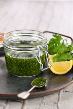 Green delicious herbal marinade of cilantro, basil, parsley, oil, traditional seasoning for salad dressing