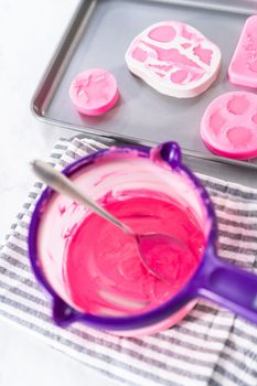 Making sea-shaped chocolates to decorate chocolate-dipped pretzels twists.