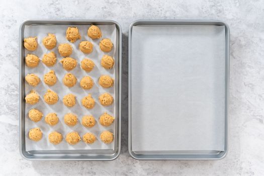 Flat lay. Scooping dough with dough scoop to bake eggnog scones.