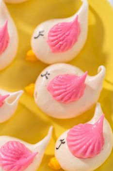 Freshly baked Easter meringue cookies in the shape of birds.