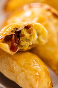 Freshly baked breakfast empanadas with eggs and sweet potato on the kitchen counter.