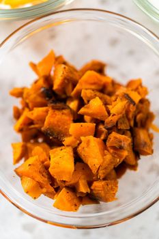 Measured ingredients in glass mixing bowls to make breakfast empanadas with eggs and sweet potato.