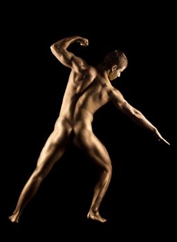 Naked strong man posing in metallic skin make-up