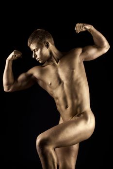 Strong athletic man naked portrait with metal skin