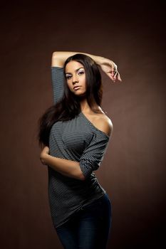 Sexy girl undress striped tank top in dark jeans