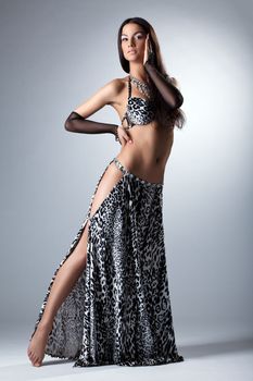 Beauty woman dancer with long hairs posing in arabian costume