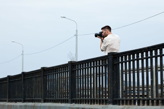 man Photograph shoot from bridge in summer city