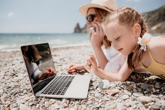 Woman sea laptop. Business woman in yellow hat working on laptop by sea. Close up on hands of pretty lady typing on computer outdoors summer day. Freelance, digital nomad, travel and holidays concept.