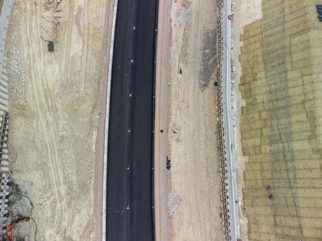 Aerial drone shot Road construction in progress in wild nature canyon.
