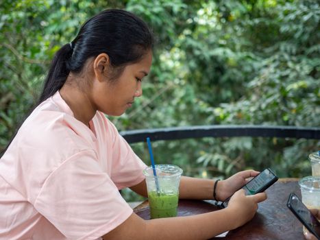 Woman staring at phone screen in coffee shop