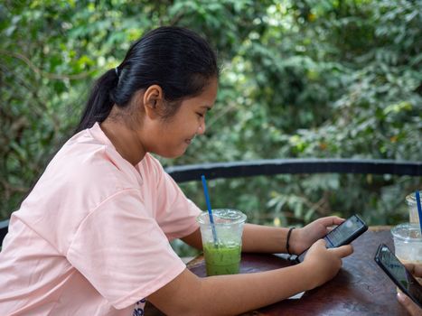 Woman staring at phone screen in coffee shop