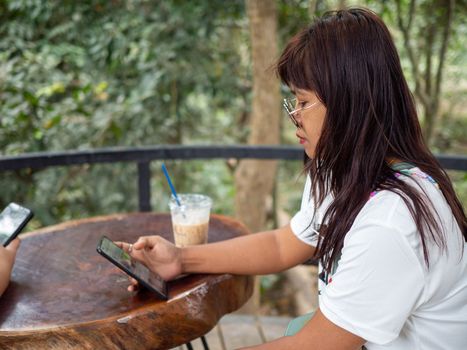 Woman staring at phone screen in coffee shop