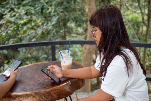 Woman staring at phone screen in coffee shop