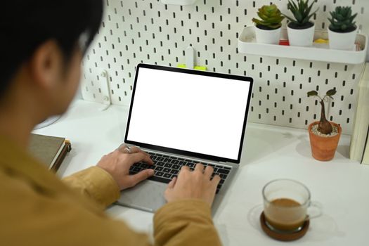 View over shoulder businessman working with laptop at comfortable office.