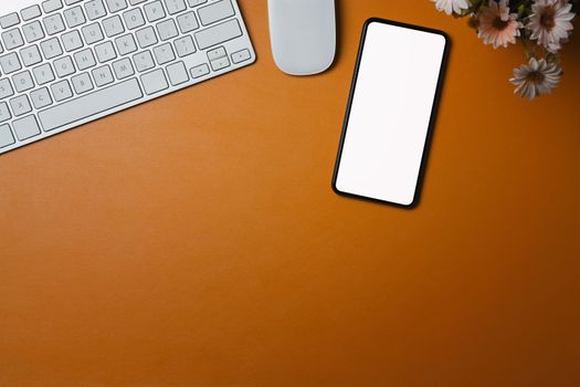 Mock up smart phone with blank display on orange leather.