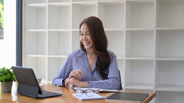 Smiling businesswoman having video conference on laptop computer.