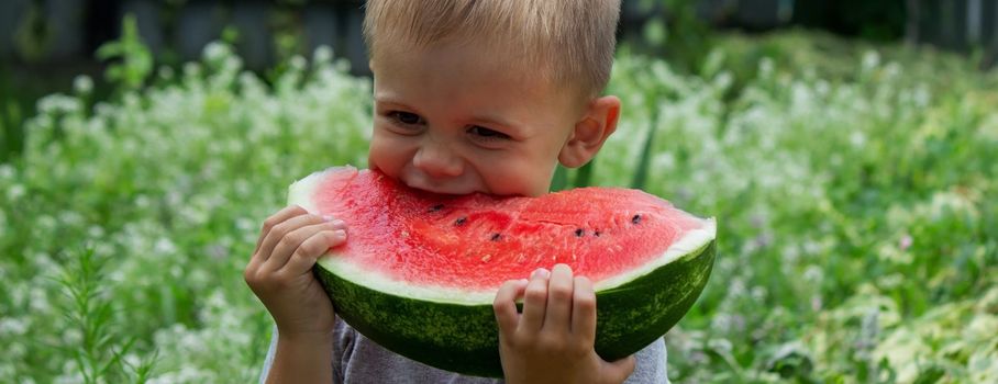 A child eats a watermelon. Selective focus. Nature