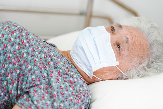 Asian elderly woman patient wearing a mask for protect Covid-19 Coronavirus.
