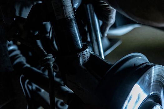 Mechanic hands detail during a maintenance of car brakes