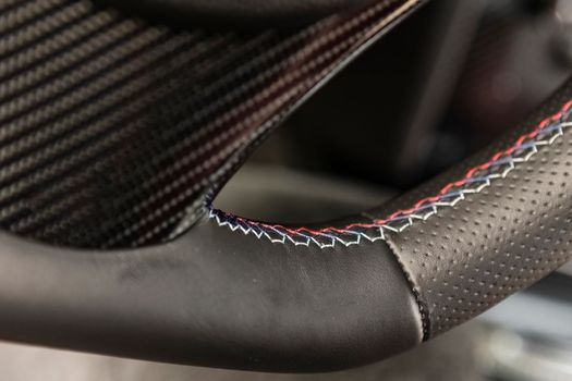 Luxury sport car steering wheel stitching detail