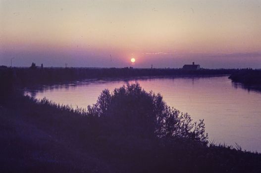 Rovigo, Italy october 1976: Po valley natural landscape at sunset in 70s