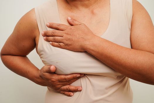 Asian woman self touching check lump or Breast cancer, Breast Self Exam. 