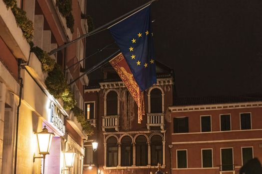 European flag on italian building at night