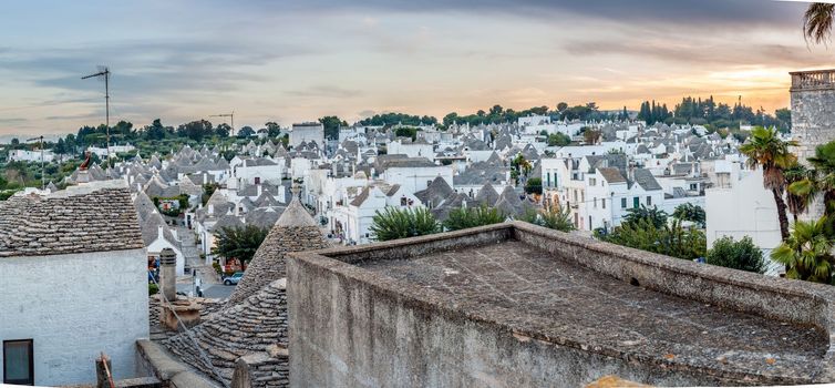 Cityscape over the traditional roofs of the Trulli, original and old houses of this region, Apulia. Typical buildings built with a dry stone walls and conical roofs.