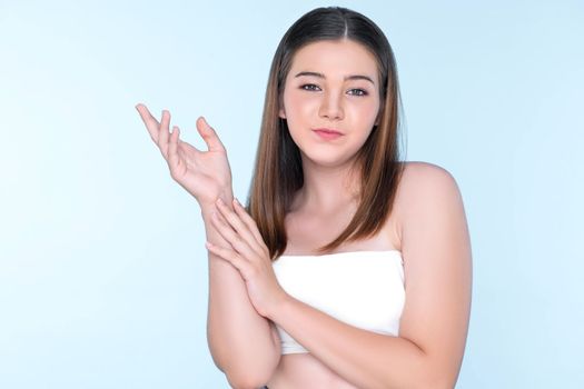 Portrait of young brunette with long hair and flawless skin with hand gesture for beauty and cosmetic concept. charming beautiful young girl posing hands for skincare or cosmetic advertising.