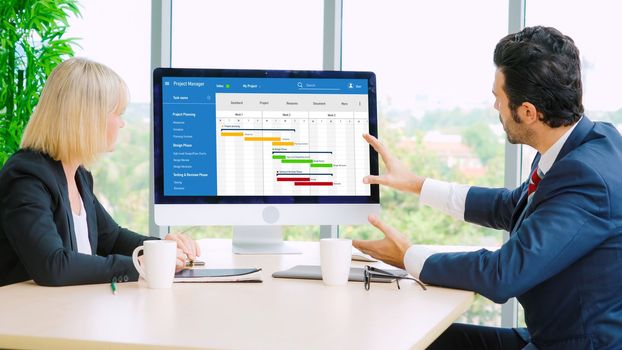 Project planning software for modish business project management on the computer screen showing timeline chart of the team project