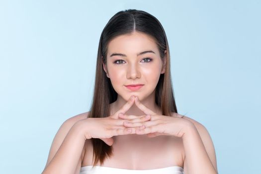 Portrait of young brunette with long hair and flawless skin with hand gesture for beauty and cosmetic concept. charming beautiful young girl posing hands for skincare or cosmetic advertising.