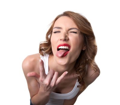 Funny young woman in white tank top show tongue isolated