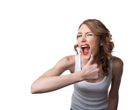 Funny young woman show thumbs up sign and smile isolated