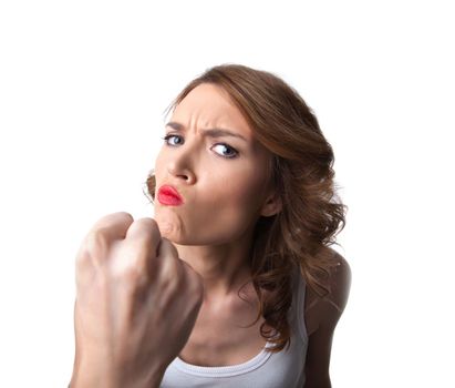 Funny young woman in white tank top show danger fist isolated